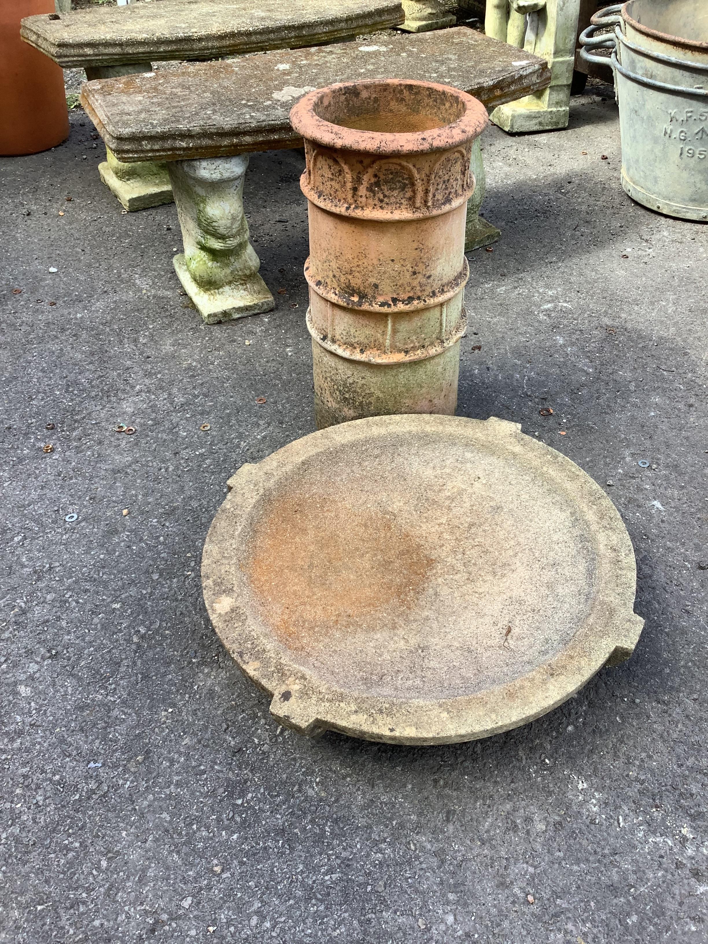 A circular stone bird bath, diameter 56cm together with a terracotta chimney pot garden planter